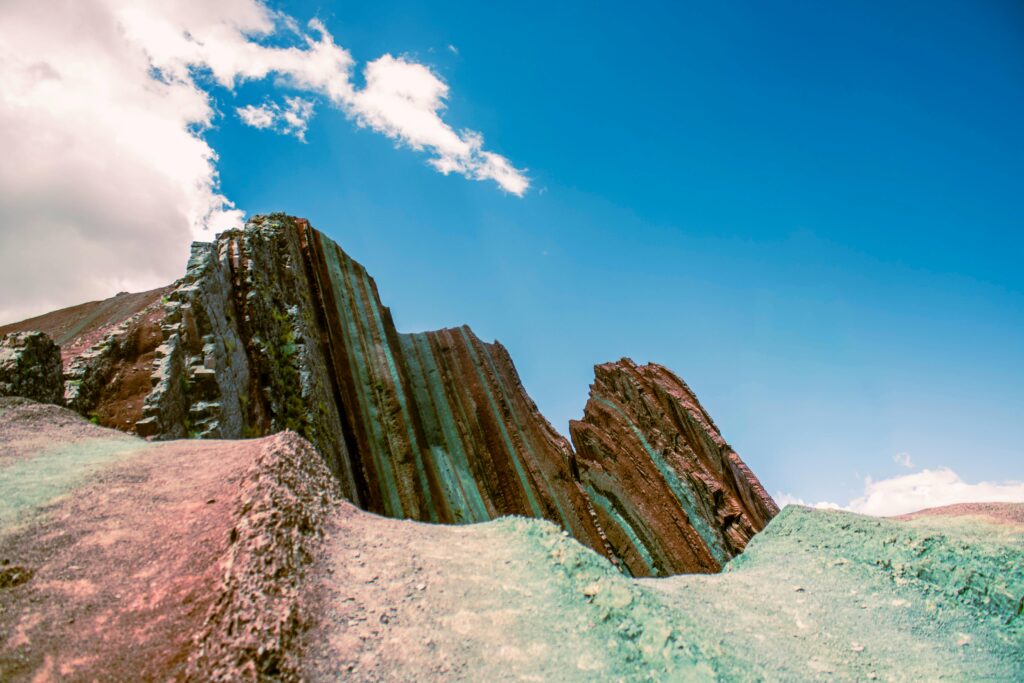 Stunning view of the colorful layers of Rainbow Mountain, Cuzco, Peru under a clear sky.